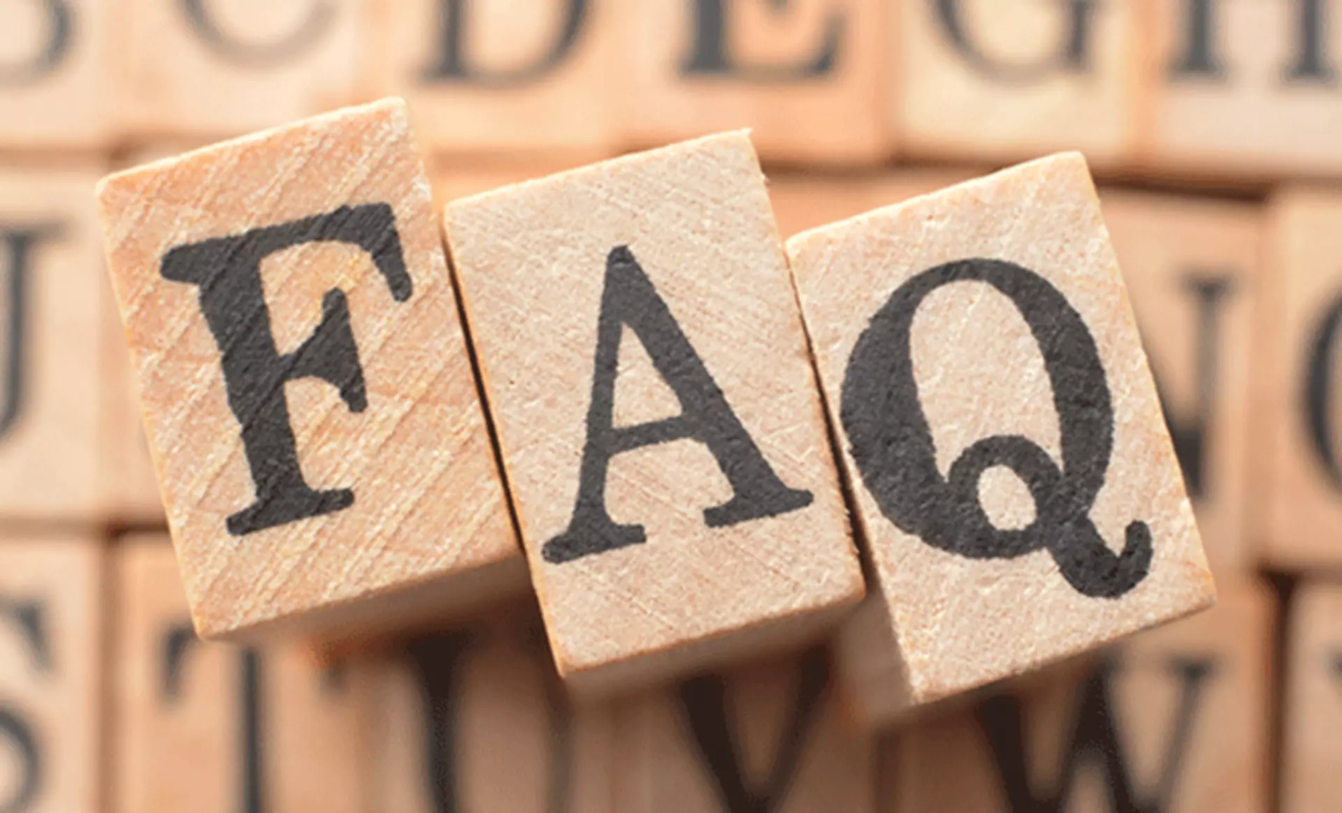 Schriftzug FAQ auf holz-würfeln