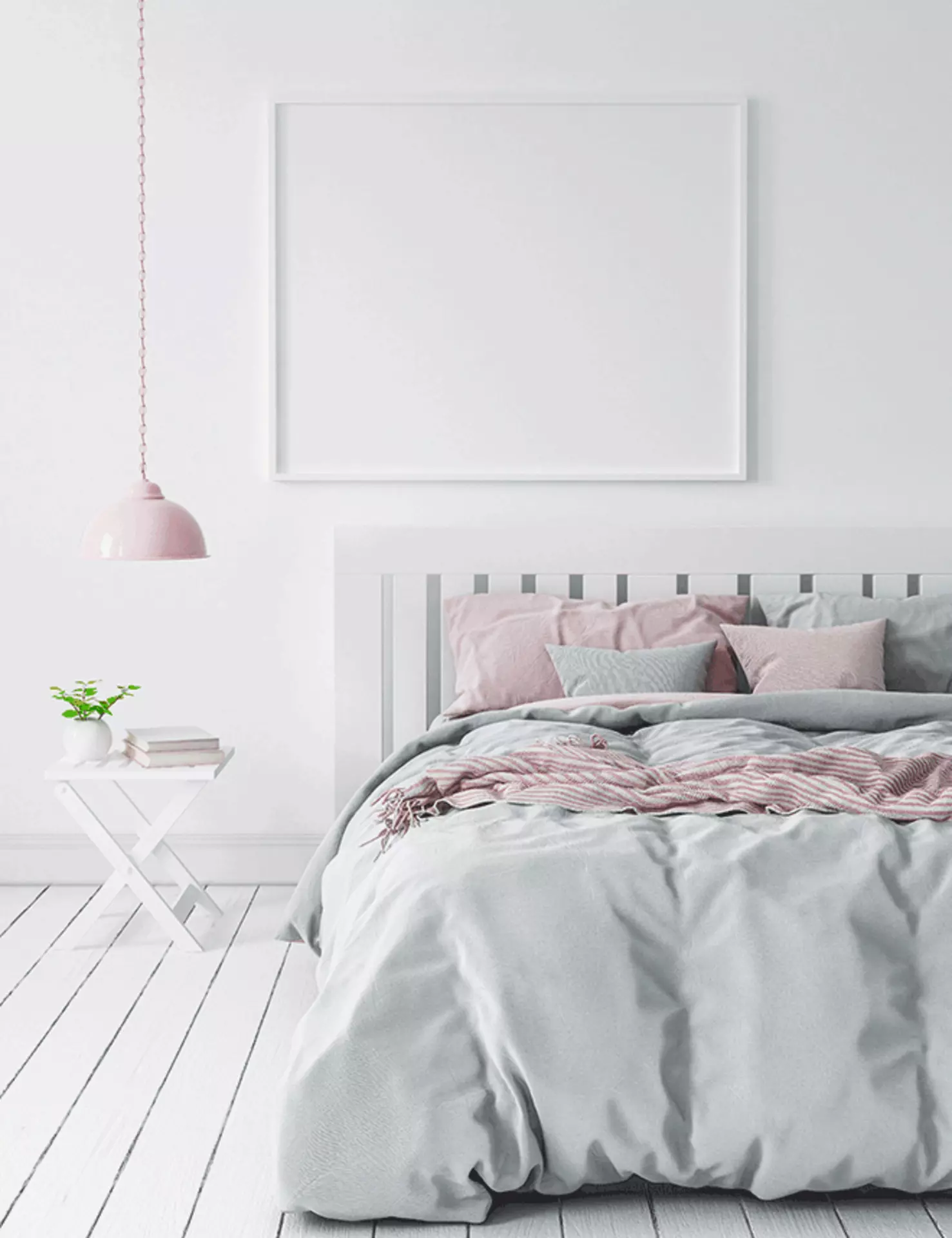 ein Bett mit grauen, weißen und rosafarbenen Bettwäsche und Kissen