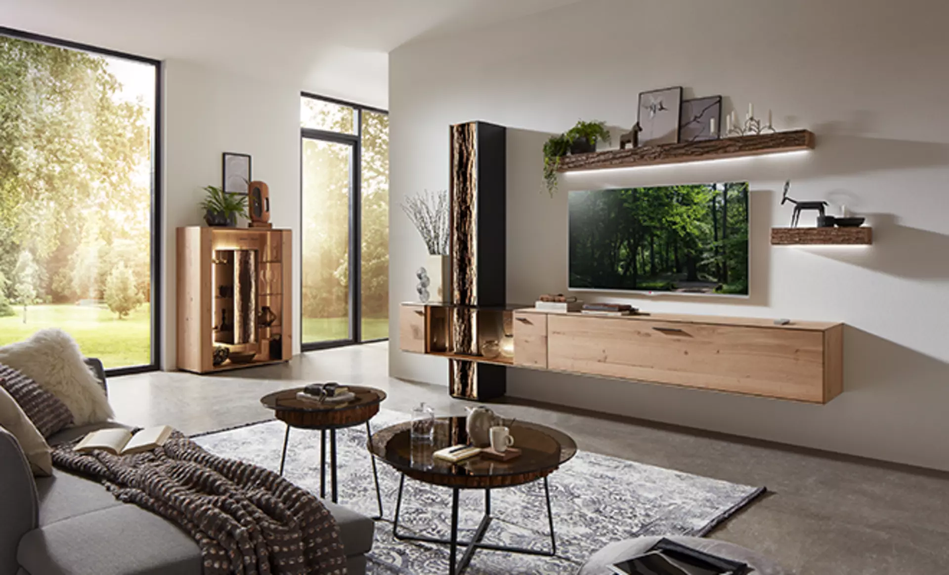 Naturbelassenes Holz und rause Maserungen sind im Japandi 2.0 oder auch textured earth die richtige Wahl für Ihre Stauraummöbel, wie diese Wohnwand und Vitrine von hartmann