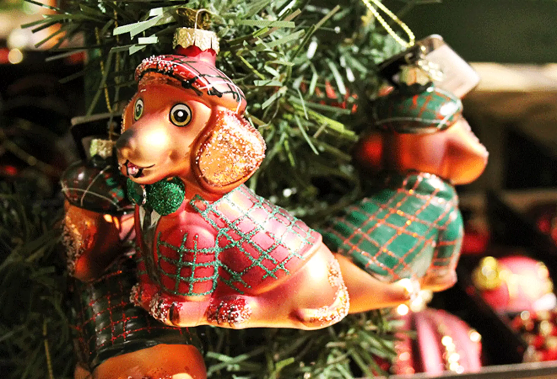 Gläserne Weihnachtsbaumanhänger in Form von Dackeln mit rot-grünem Karo-Muster