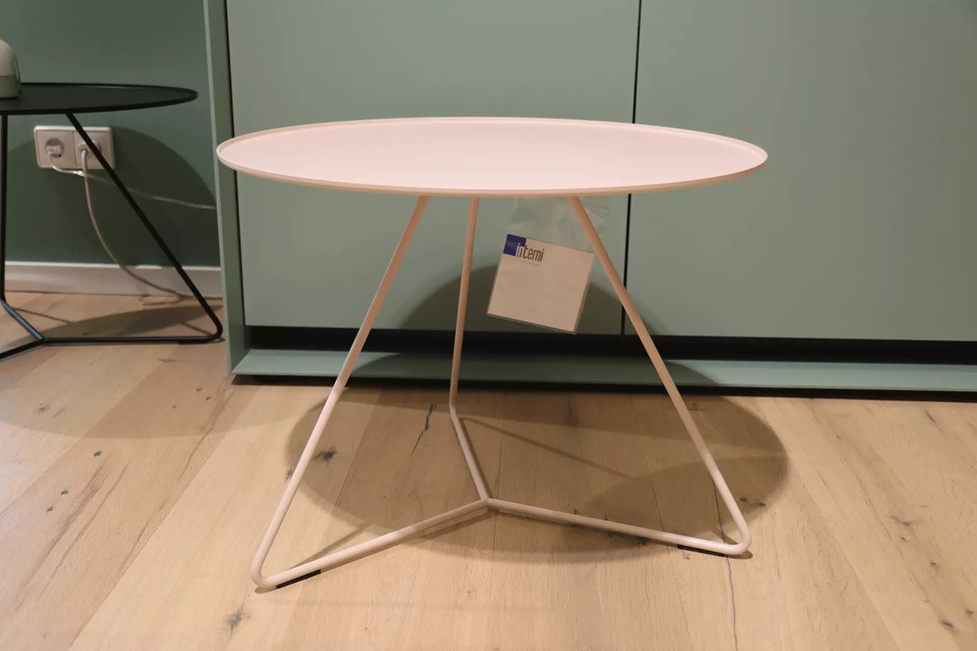 Der Steely Beistelltisch von Möller Design frontal abgebildet miti seinen dünnen Gestellbeinen ausgestellt bei interni by Inhofer