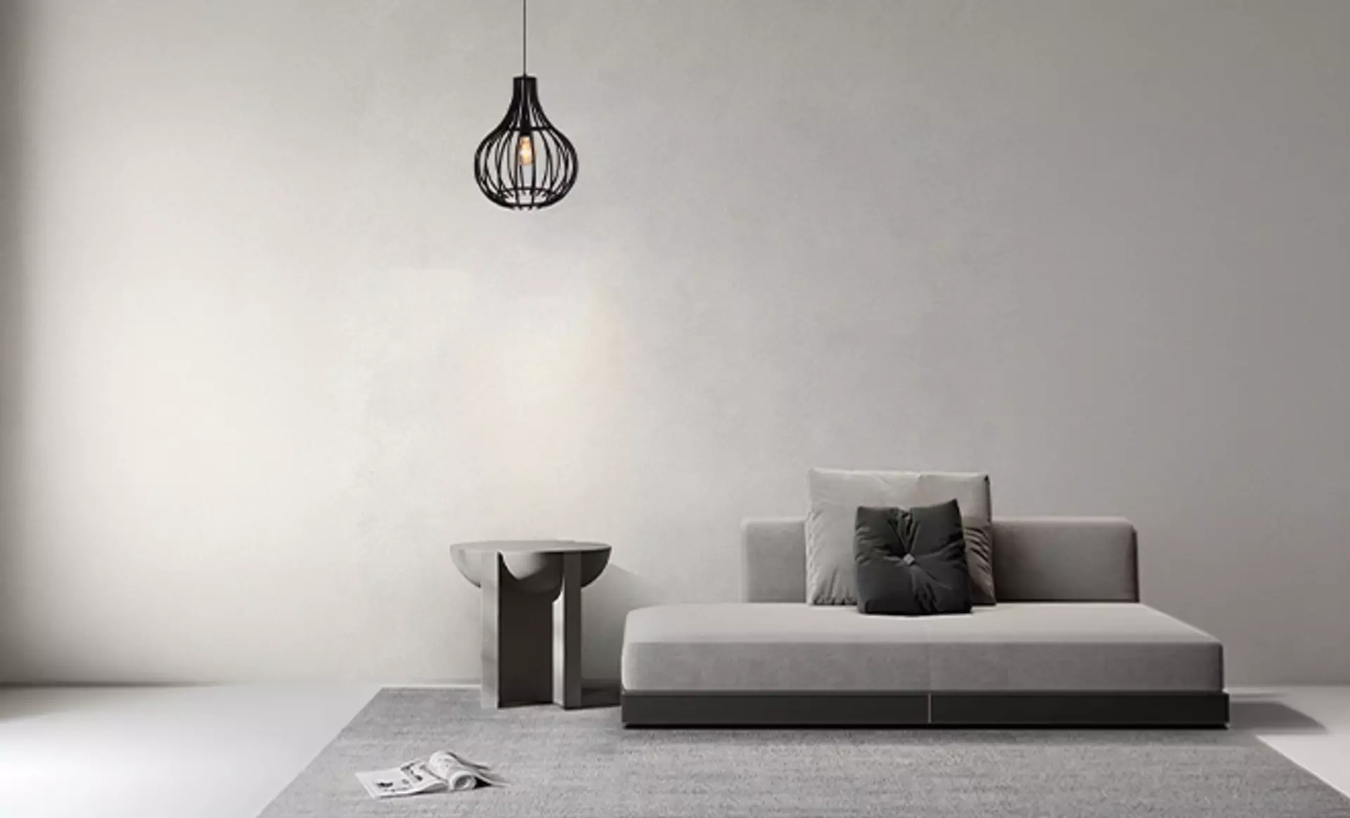 Die Cipolle Pendelleuchhte 1-Strahlig mit ihrem schwarzen Gitterkorb über einem minimalistischen grauen Sofa hängend.