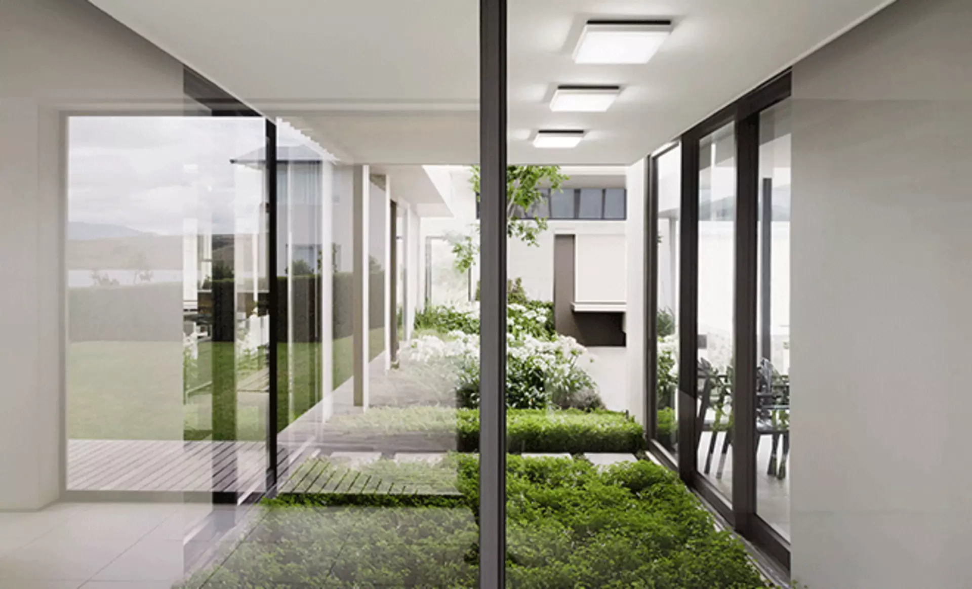Halboffener Indoor-Garten in einem modernen Zuhause mit Deckenleuchten von Fabas Luce.