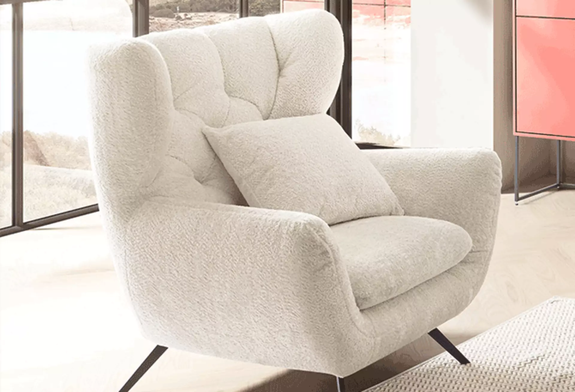 Weißer Bouclé-Sessel in einem schlichten, modern eingerichteten Wohnraum